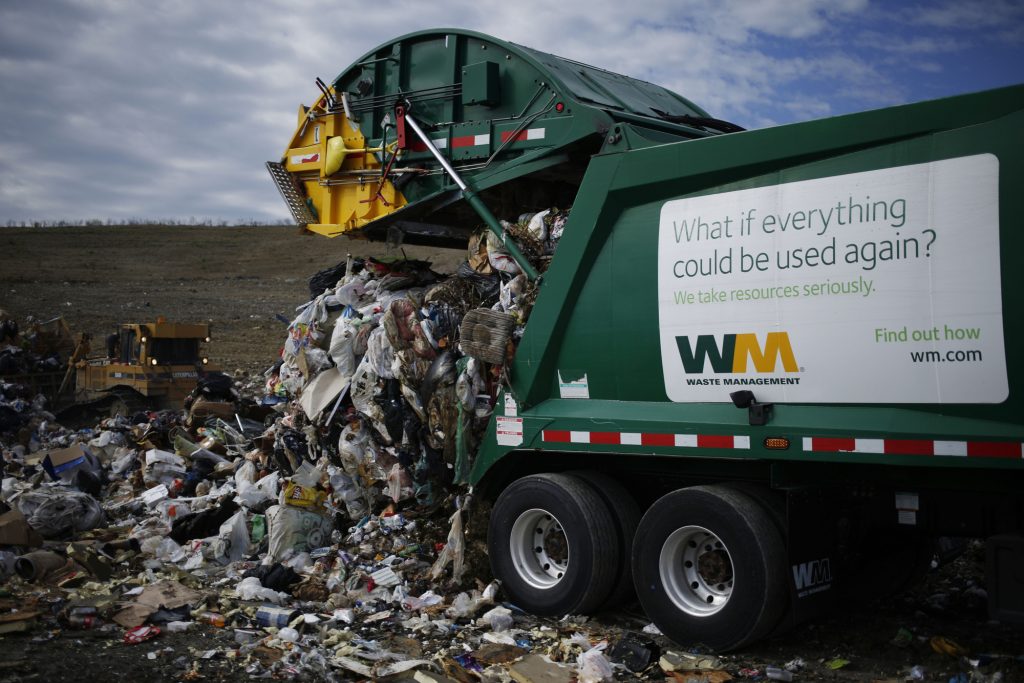 A Waste Management, Inc. garbage truck dumps a load of trash at the Waste Management Skyline Landfill in Ferris, Texas, U.S., on Monday, Oct. 24, 2016. Waste Management is scheduled to release their next quarterly earnings on October 26. Photographer: Luke Sharrett/Bloomberg